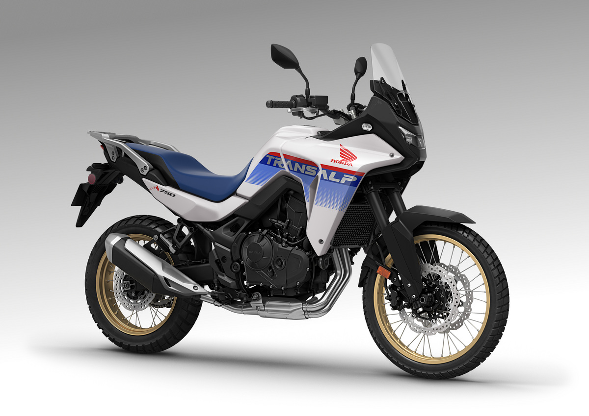 studio photo of a white Honda Transalp with red and blue accents
