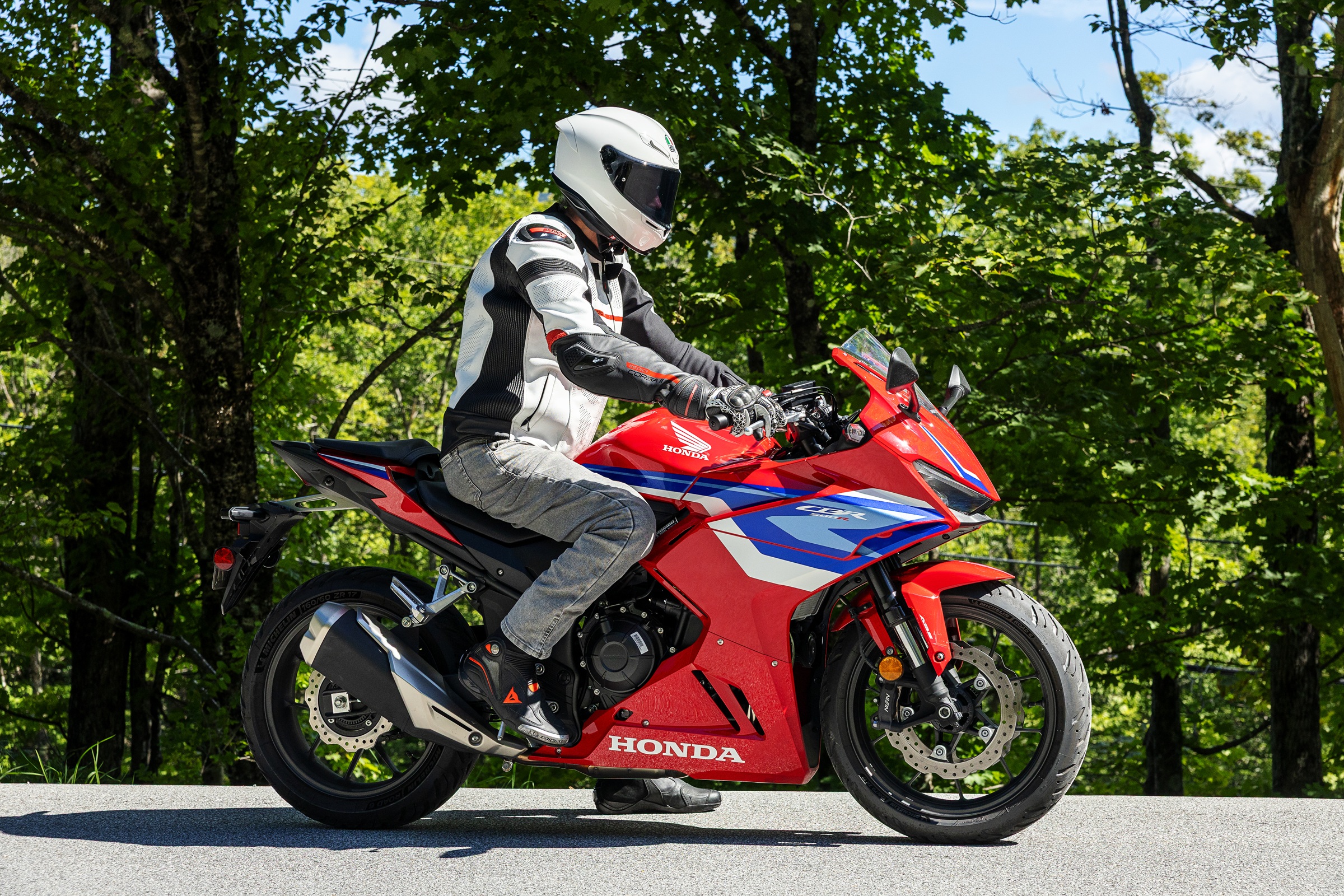 side view of the rider sitting on the CBR500R to show the nearly upright riding position