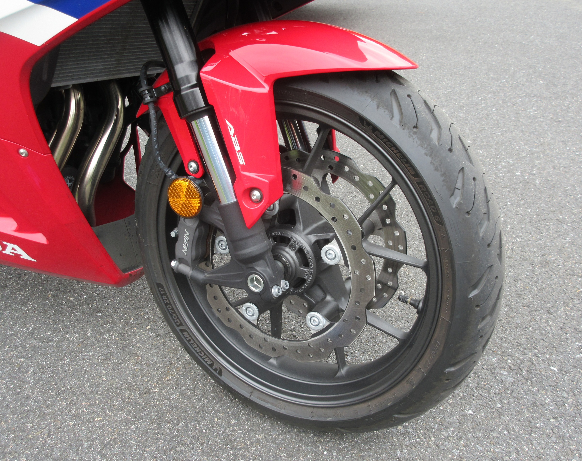 close view of the front wheel, suspension, and brakes on the Honda CBR500R