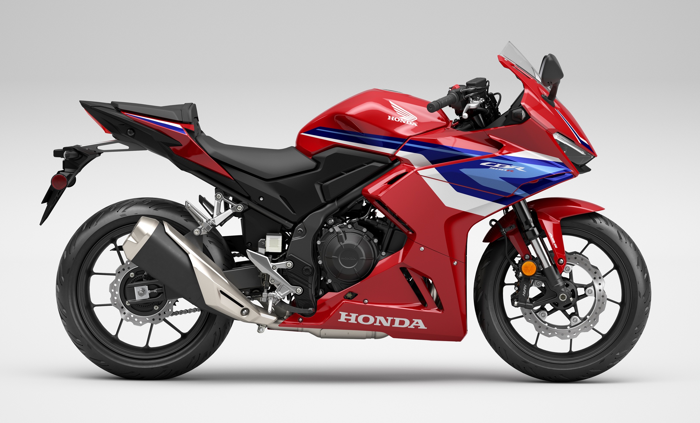 studio photo of the red Honda CBR500R with blue and white accents
