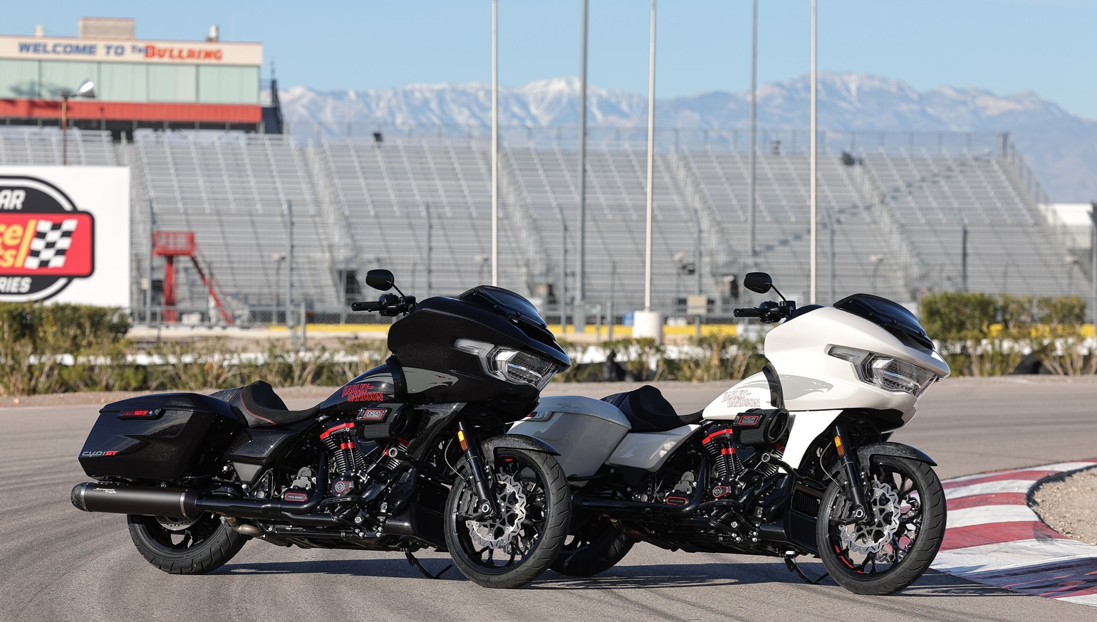 2024 Harley-Davidson CVO Road Glide STs in two colors, Golden White Pearl and Raven Metallic, parked at Las Vegas Motor Speedway