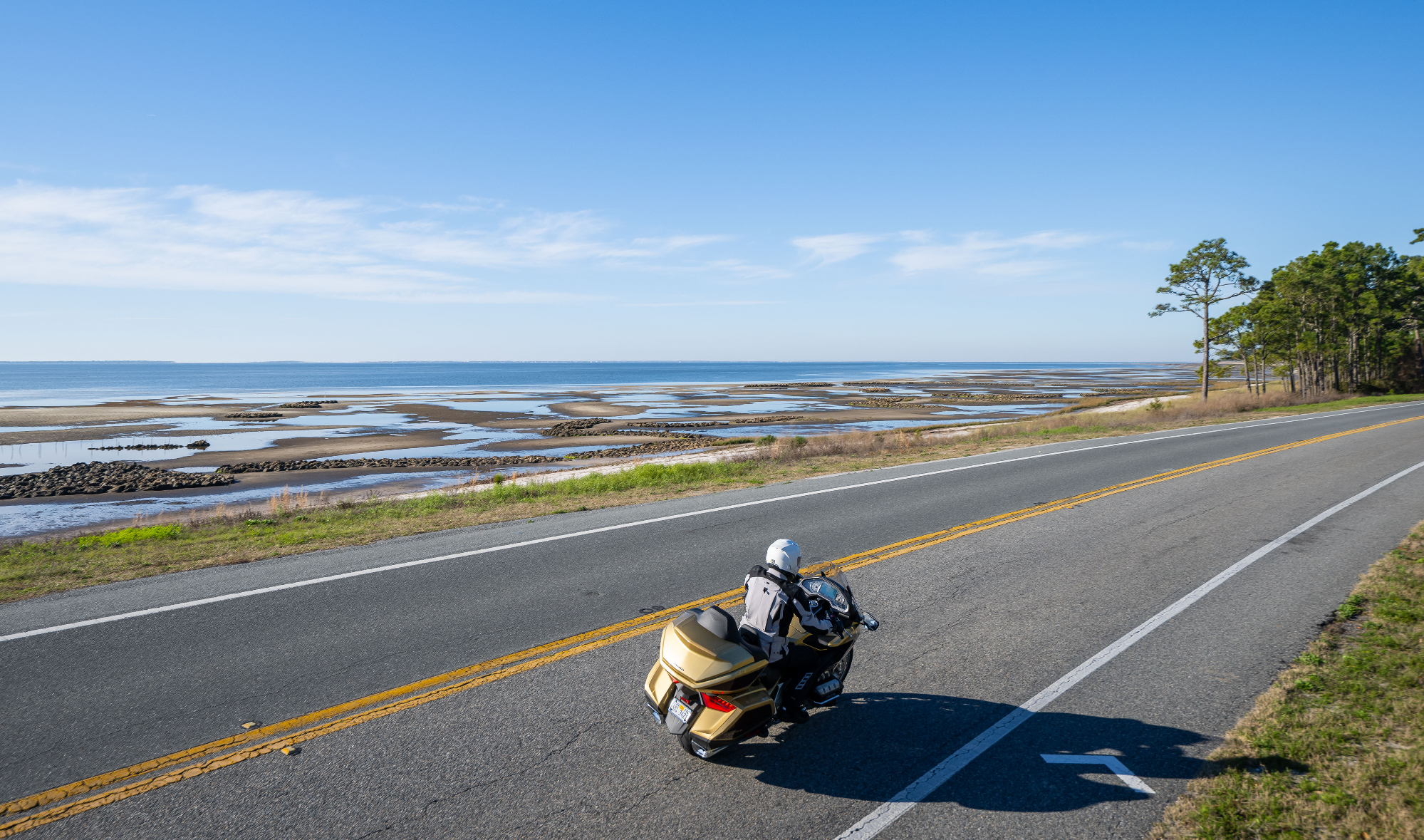 aerial view of me riding a Gold 50th Anniversary 2025 Gold Wing Tour on a coastal road in Florida on a sunny day
