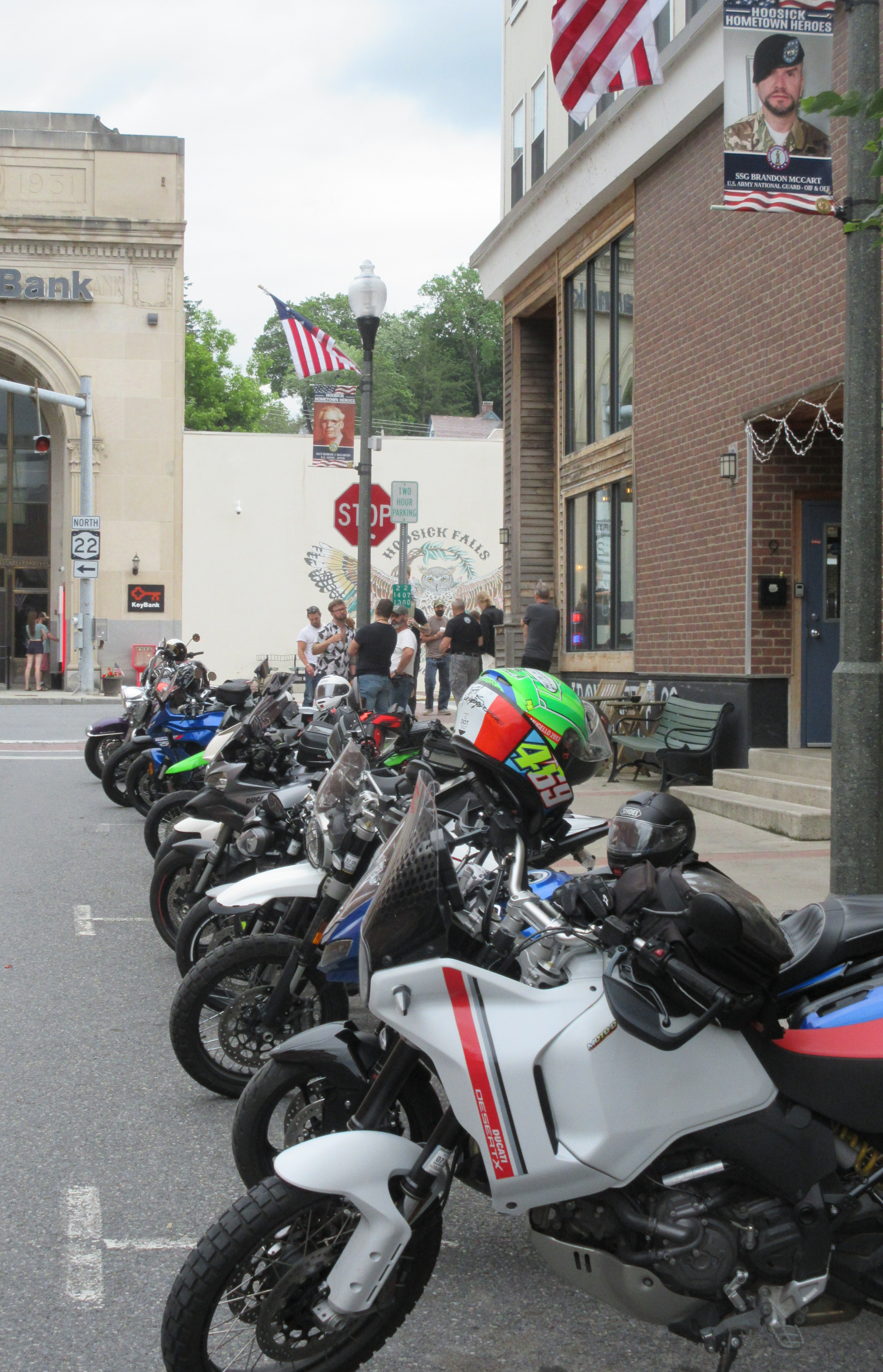 row of motorcycles parked outside Iron Coffee Company on a street in the small town of Hoosick Falls
