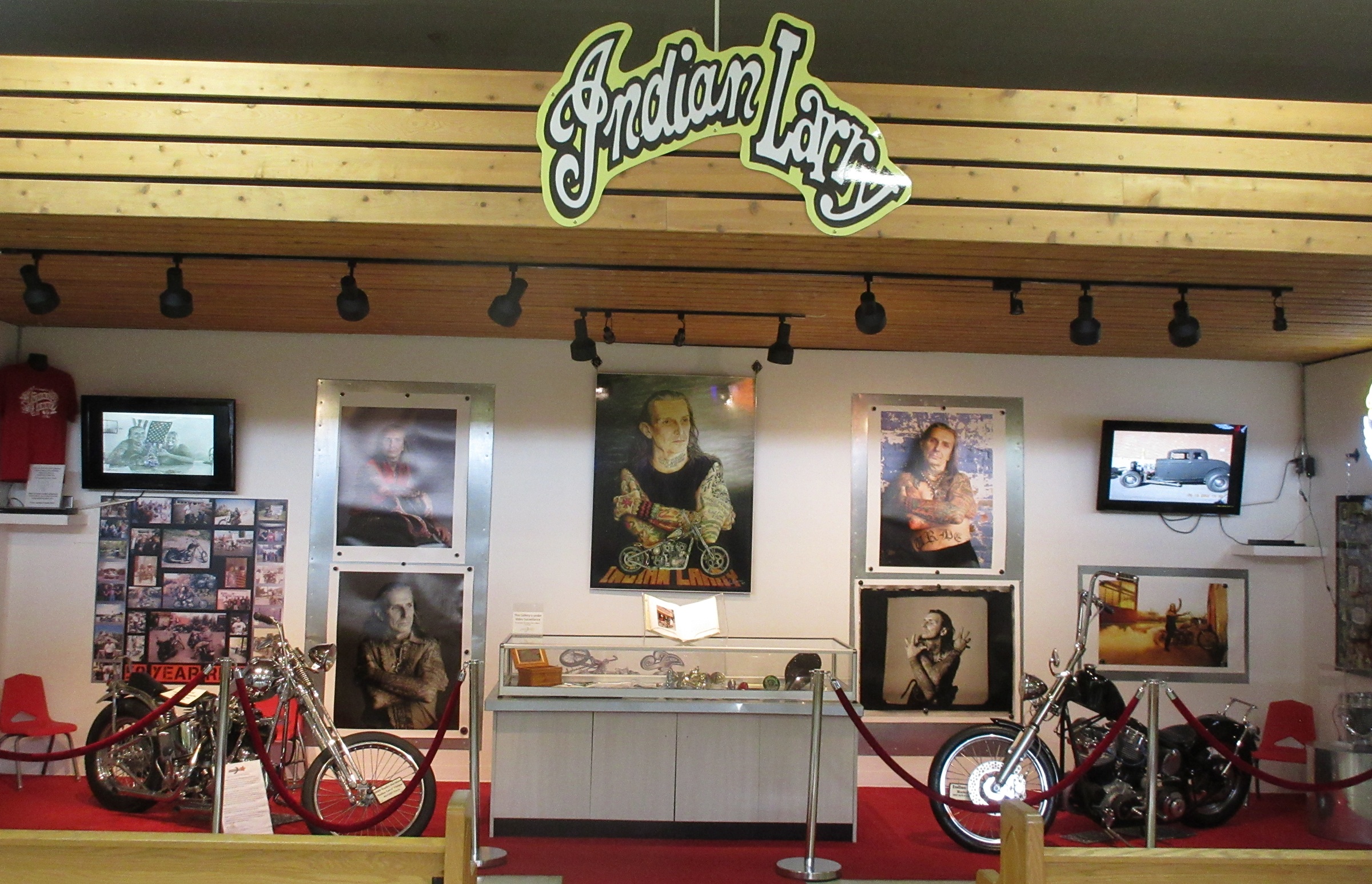 museum display of photos and information on custom builder Indian Larry and two motorcycles he built