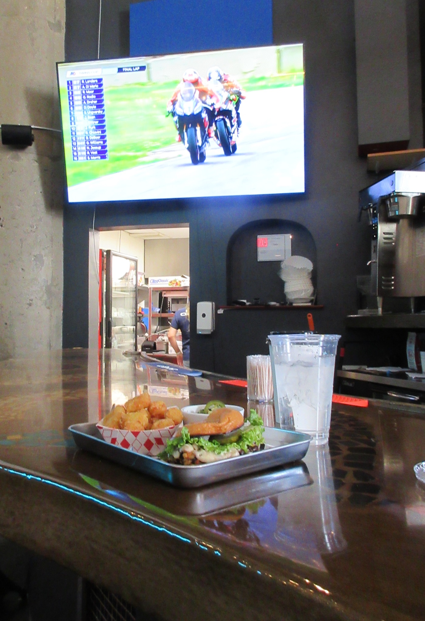 meal on the bar with the TV tuned to motorcycle racing