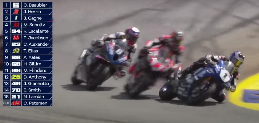 Josh Herrin slices through a narrow gap between two other motorcycles in the corner with not even inches to spare