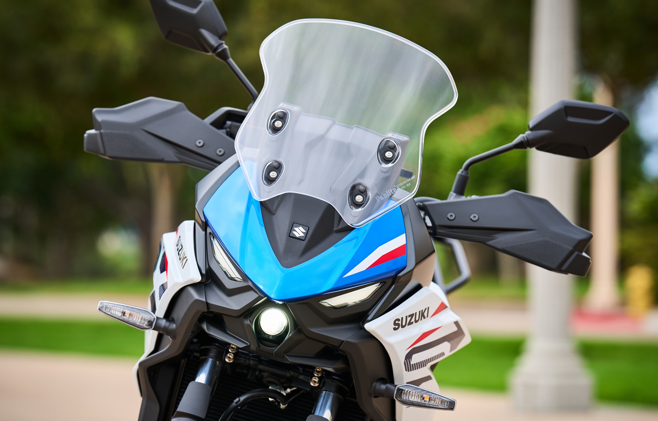 front view of the blue and white SV-7GX showing the small projector-style headlight