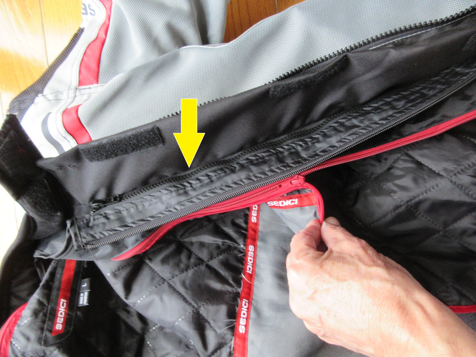 close view of the zippers attaching the two liners to the shell of the jacket