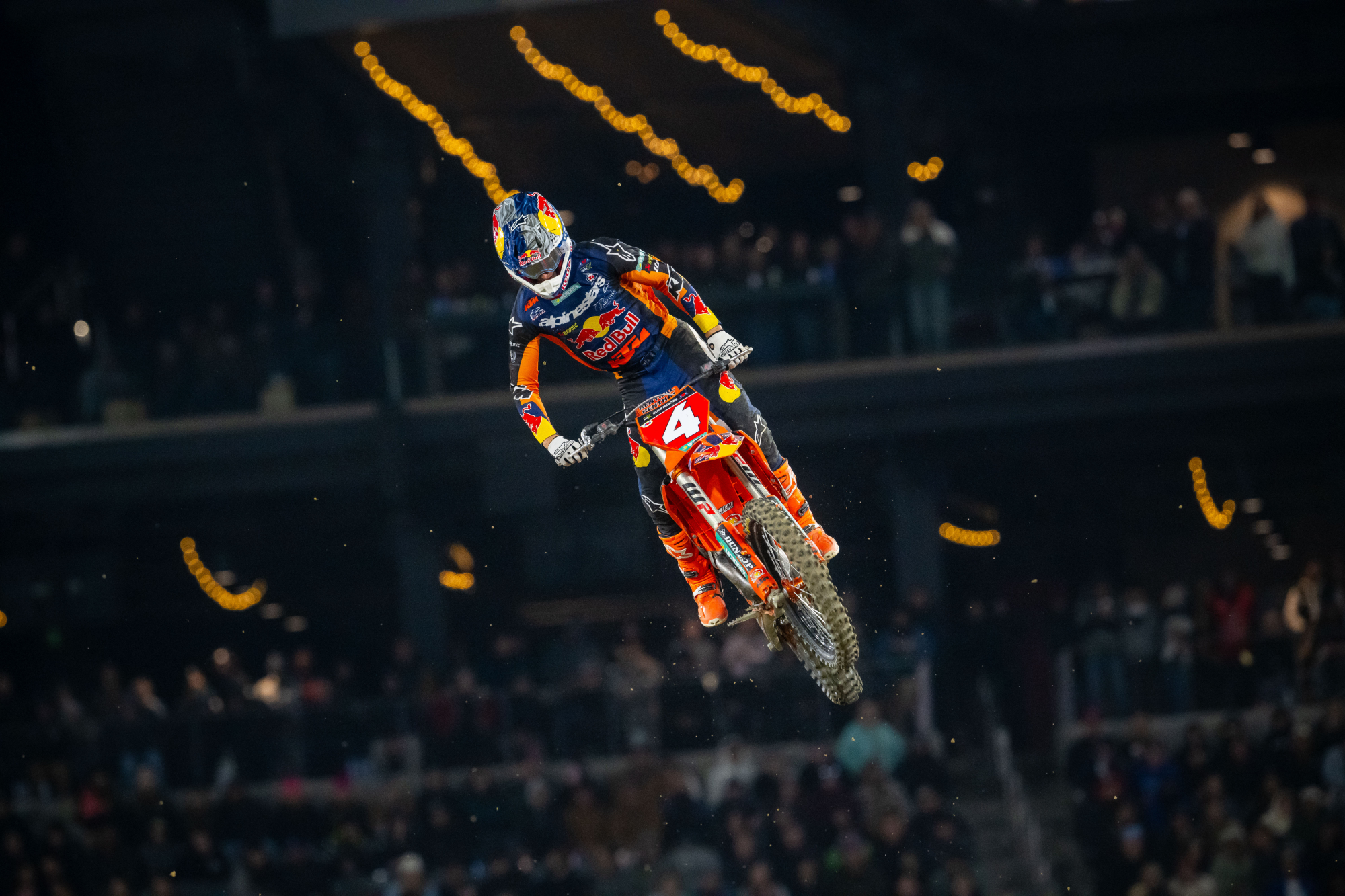 Chase Sexton flying through the air at the San Diego Supercross race with the red number plate on his KTM and fans in the background