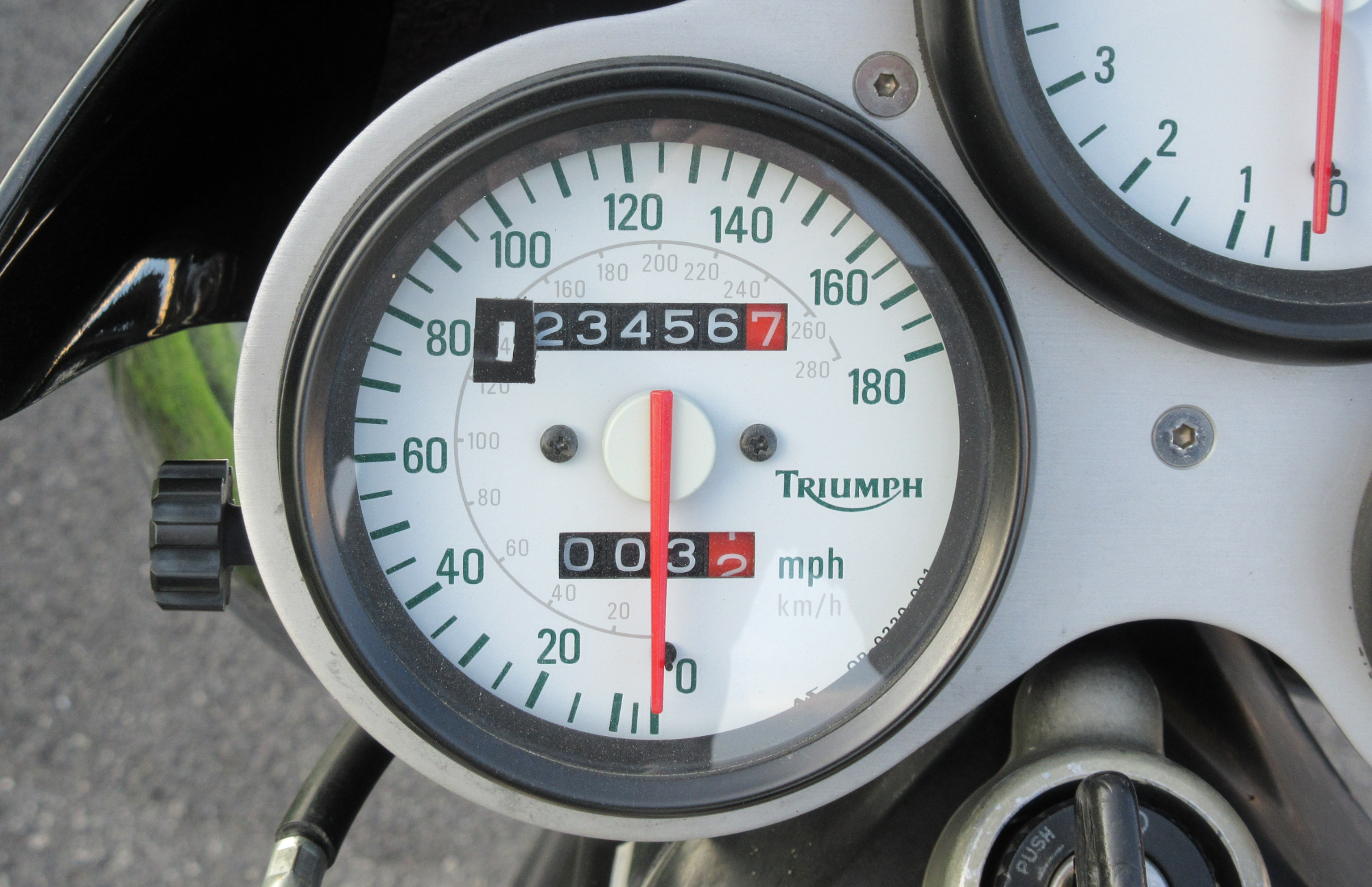 motorcycle odometer showing 123,456.7 miles