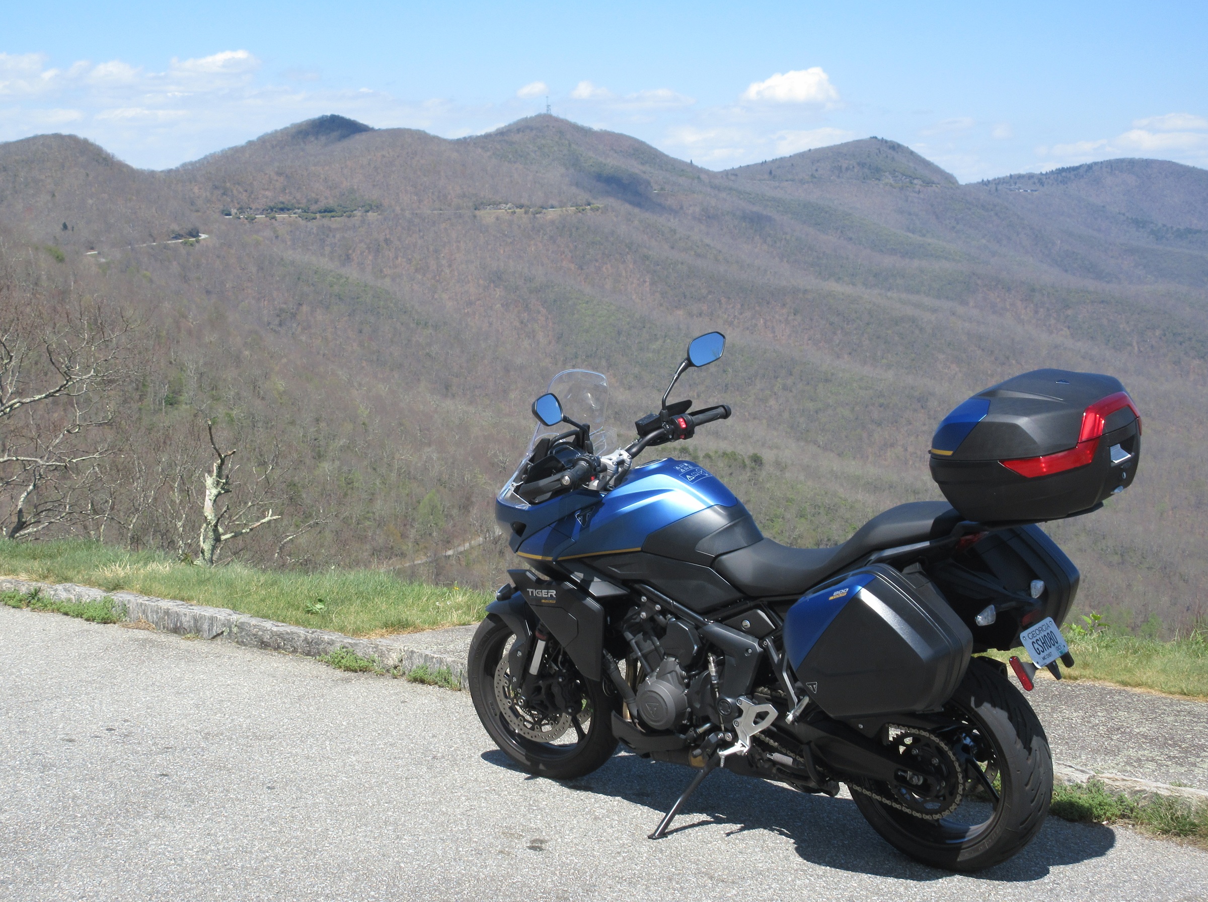 blue Triumph Tiger Sport 800 Tour parked at an overlook in the mountains along the Blue Ridge Parkway
