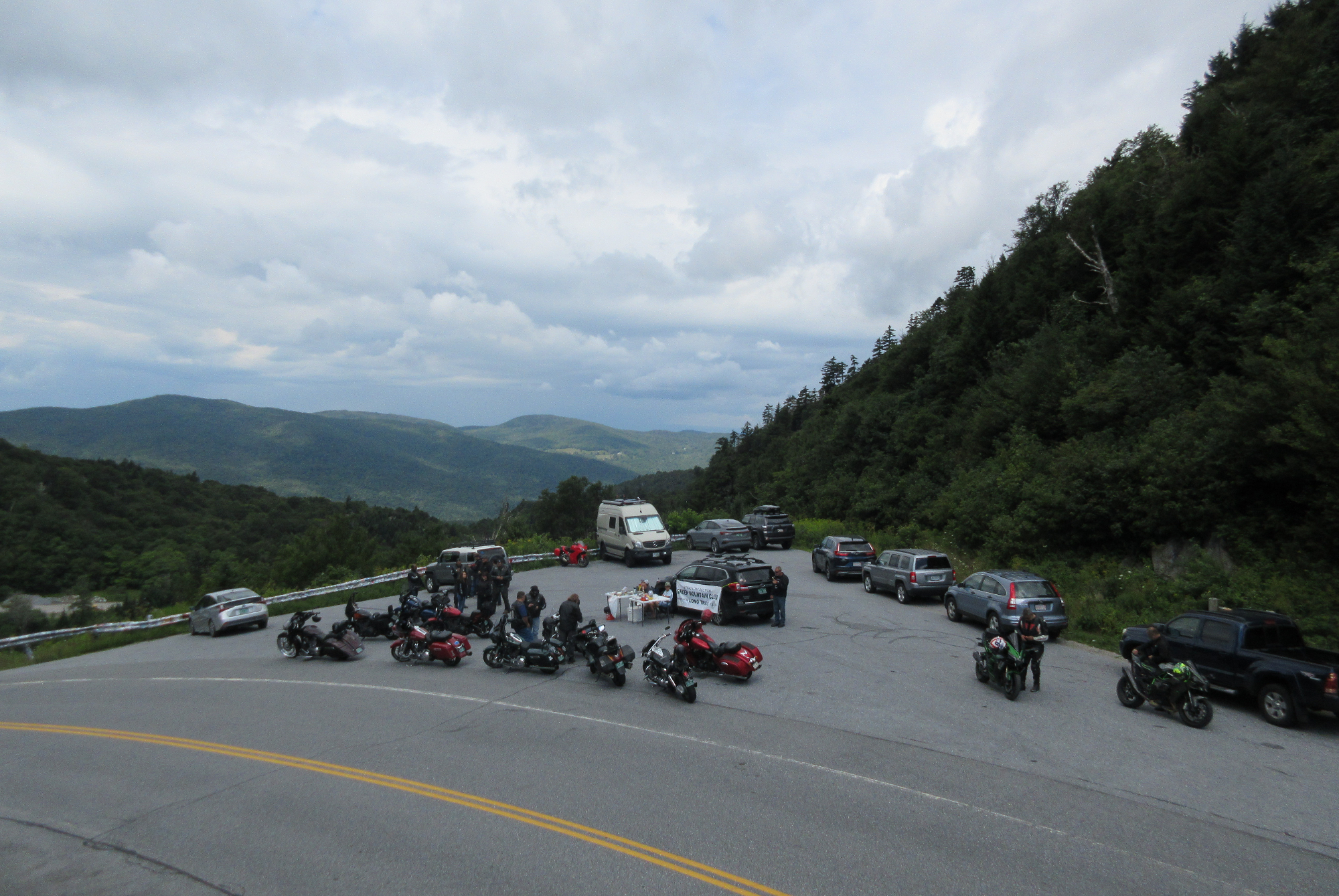 view from above of motorcycles and cars parked at the overlook atop Appalachian Gap in Vermont